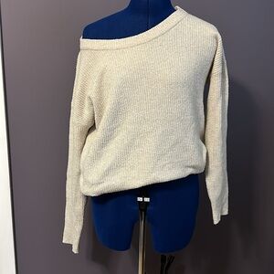 Cream colored sweater with a wide neck